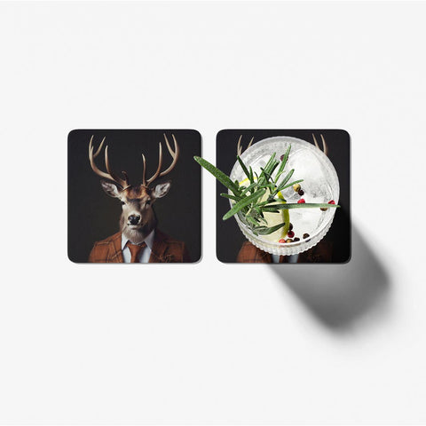 Two coasters with a deer and a cocktail design on a white background
