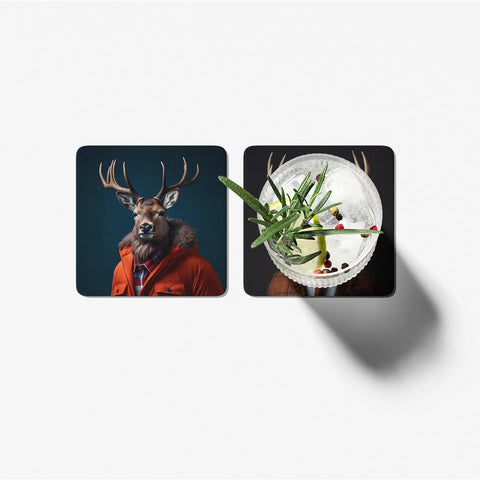 Two coasters with a deer wearing a coat and a cocktail with herbs on a white background