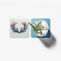 Two coasters with different designs on a white background