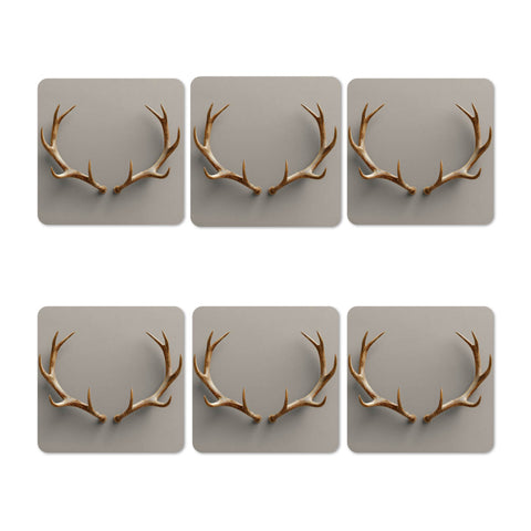 Six coasters with deer antler designs on a gray background