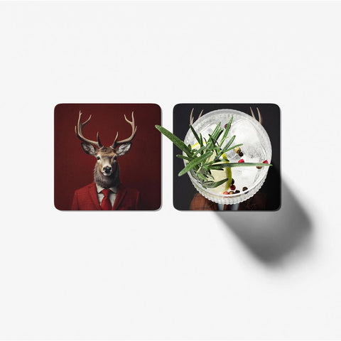 Two coasters with a deer in a suit and a cocktail with herbs on a white background