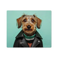 A vinyl mouse pad with a whimsical dog head design, wearing a leather jacket and a green scarf, on a blue background.