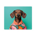 A vinyl mouse pad with a whimsical dog head design in the center, with a colorful floral pattern on the dog's shirt, against a solid teal background.